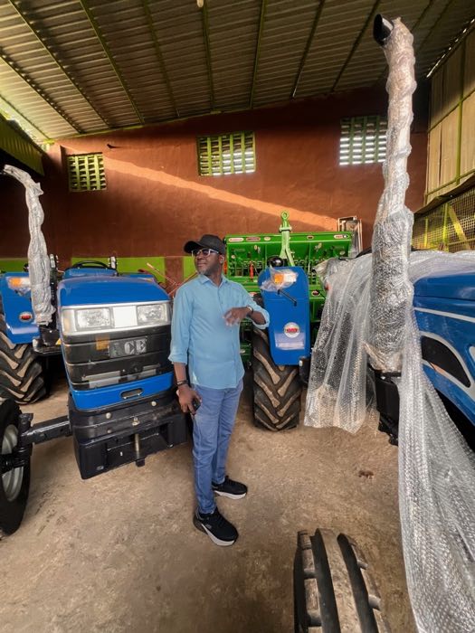 Adani Abdallah beside tractors in an equipment centre